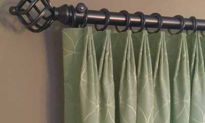 Stunning decorative iron drapery hardware with patterned curtains.