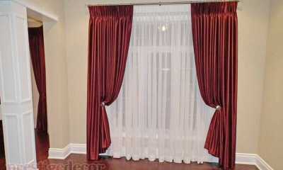 Elegant curtains with sheers on an iron curtain rod with crystal finials and matching holdbacks
