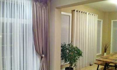 Elegant pinch pleat curtains and grommet curtains in the living room and dining room