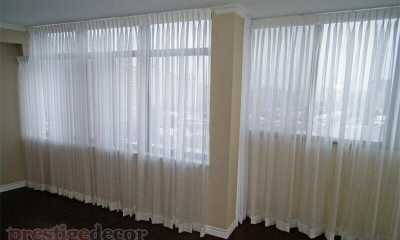 Elegant sheer curtains in the living room and dining of a condo in Toronto