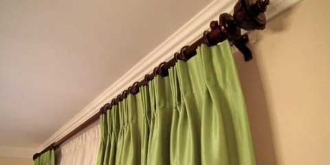 green draperies with sheers and crystal holdbacks