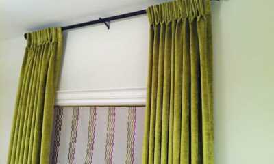 Green velvet draperies and roman blinds