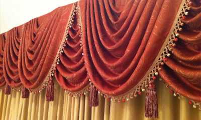 Silk drapery behind swags from rich fabric