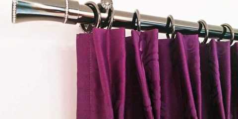Stunning purple curtains with gorgeous iron drapery hardware.