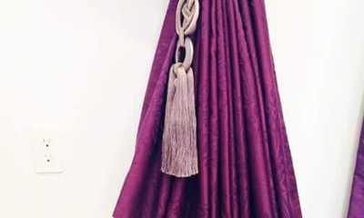 Stunning purple curtains with luxurious tiebacks.