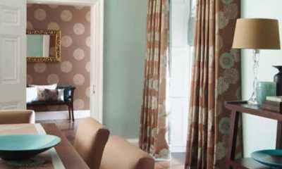 Very trendy drapes with a valance and matching wallpaper