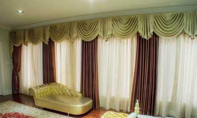 Luxurious window treatments on a remote controlled track in the master bedroom of a Villa on Mississauga Road