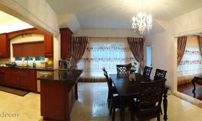 Roller blinds in the kitchen and draperies in the dining and living areas in Mississauga.