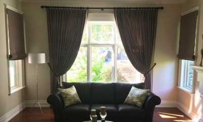 Brown pattern curtains with tiebacks and roman blinds in an Oakville villa
