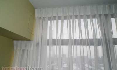 Sheer curtains spanning from wall to wall in a condo in Toronto