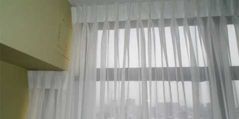 Sheer curtains spanning from wall to wall in a condo in Toronto