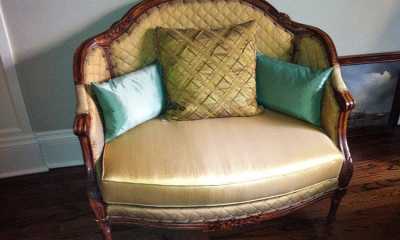 This beautiful fabric gave a royal look to this in silk upholstered chair and half. Pillows add comfort and provide an even cosier look.