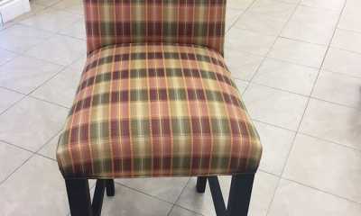 After photo of an upholstered chair with stripe fabric and matching piping