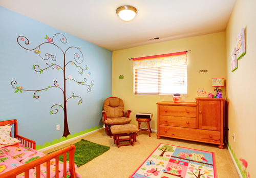 Cheerful bright nursery room with contrast and painted wall.