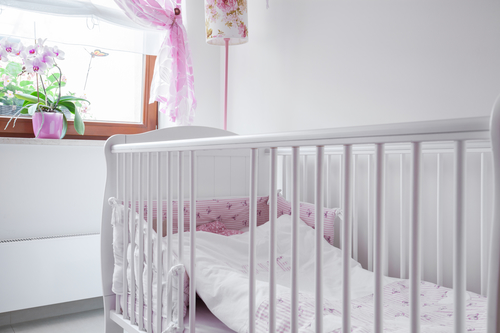 Close-up of white crib in nursery room