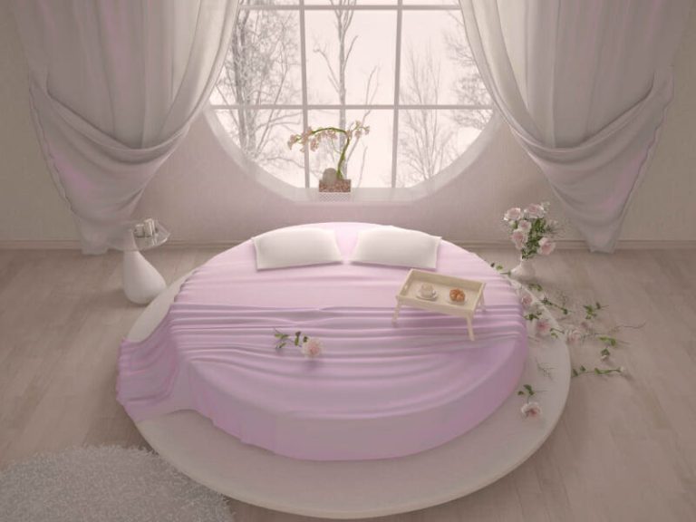 bedroom with a circular window and bed
