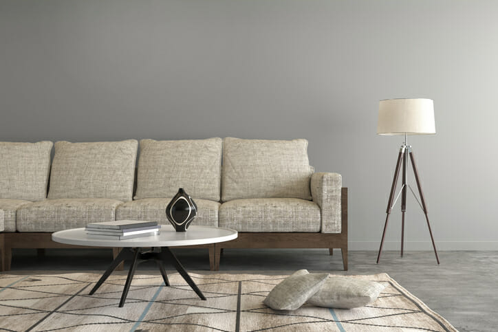 Beige sofa in a living room , letter box composition